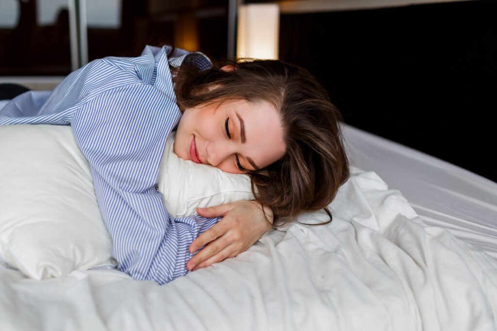 cute-woman-lying-her-stomach-bed-sleep-wearing-stylish-black-lingerie-striped-boyfriend-shirt